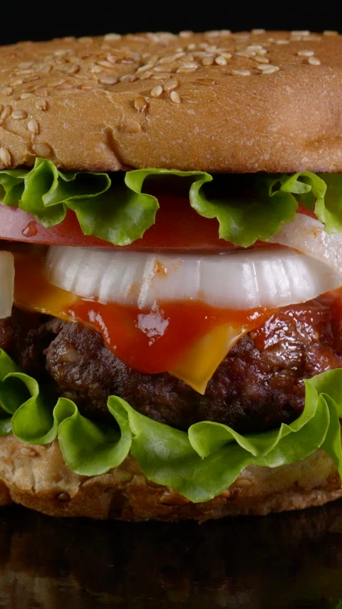 Beef Burger rotating on a black background Stock Footage 257097022