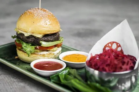 Beef burger set with lotus chips and sauces Stock Photos
