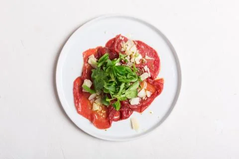 Beef carpaccio with arugula and sauce. Top view 写真素材