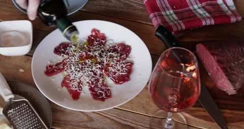 Beef carpaccio extra virgin olive oil pouring 스톡 동영상 330406381