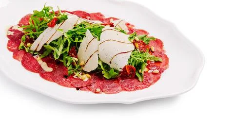 Beef carpaccio serving with arugula parmesan and pine nuts Stock Photos