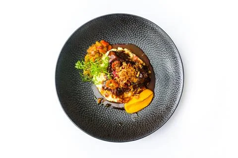 Beef cheeks with couscous risotto and vegetables isolated Stock Photos