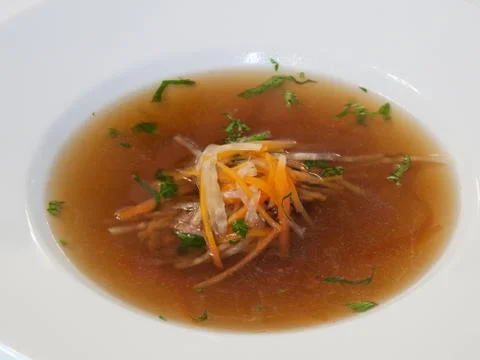 Beef consomme with root vegetables and meat Stock Photos