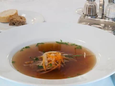Beef consomme with root vegetables and meat Stock Photos