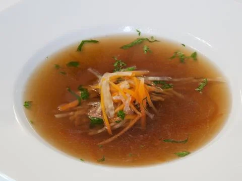 Beef consomme with root vegetables and meat Stock Photos