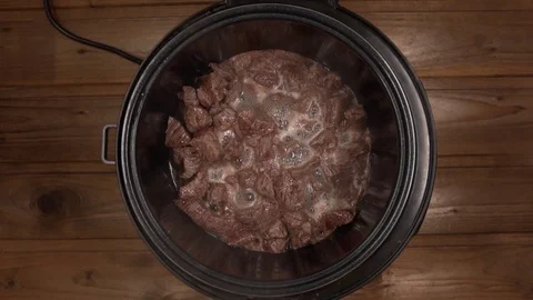 Beef cooked in a slow cooker is steam Stock Footage 129101057