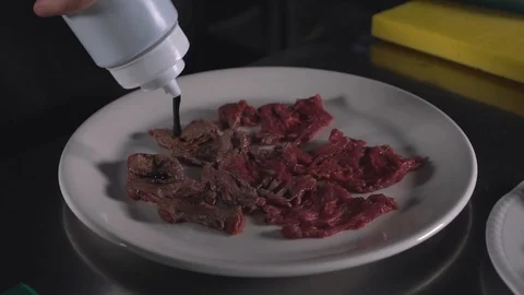 Beef cooking adding some bbq souse Stock Footage 89202192