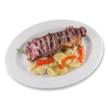 Beef cube roll dish with sliced baked potatoes. Stock Photos