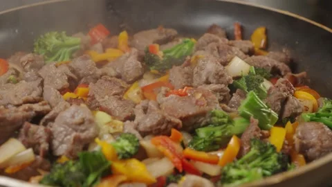 Beef Cubes with Vegetables Frying in Pan Stock Footage 321770757