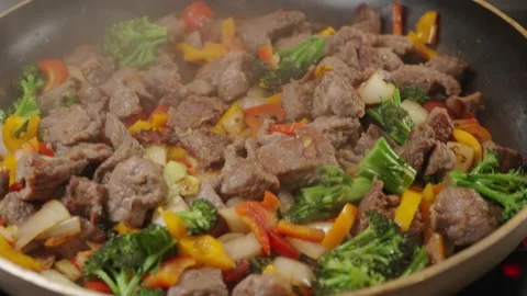 Beef Cubes with Vegetables Frying in Pan Stock Footage 321770758