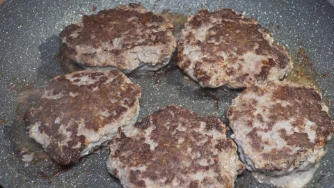 Beef cutlets being fried on the pan Stock Footage 84566447