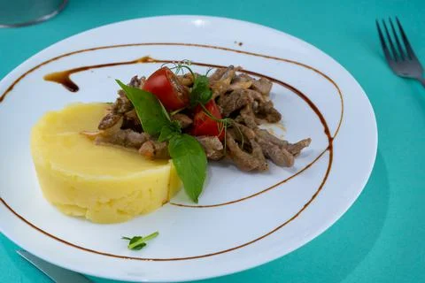 Beef cutlets meatballs with mashed potatoes on a white plate. Meat in sour cream Stock Photos