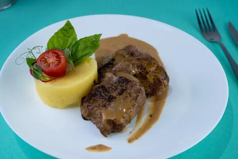 Beef cutlets meatballs with mashed potatoes on a white plate. Meat in sour cream Foto stock