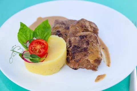 Beef cutlets meatballs with mashed potatoes on a white plate. Meat in sour cream Stock Photos