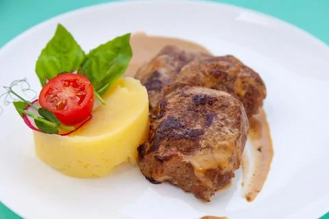 Beef cutlets meatballs with mashed potatoes on a white plate. Meat in sour cream Stock Photos