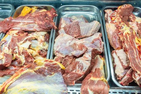 Beef cuts of various types displayed in a refrigerated showcase. Stock Photos