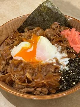 Beef don with soft eggs on the rice in the bowl for eating Stock Photos