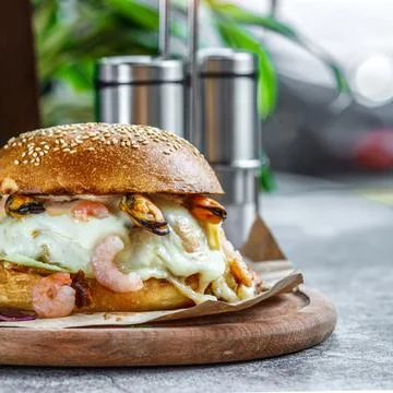 Beef Egg and Bacon Burger Served in Restaurant. American fastfood. Tasty Gour Stock Photos