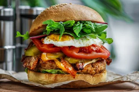 Beef Egg and Bacon Burger Served in Restaurant. American fastfood. Tasty Gour Stock Photos