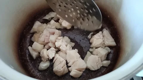 Beef fat is fried in a saucepan. Melted fat, ghee butter Stock Footage 319980656