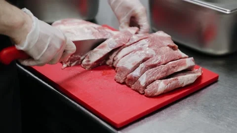 Beef fillet on the Cut Board, preparing Meat. Mans`s Hands with a Knife slicing Stock Footage 134208592