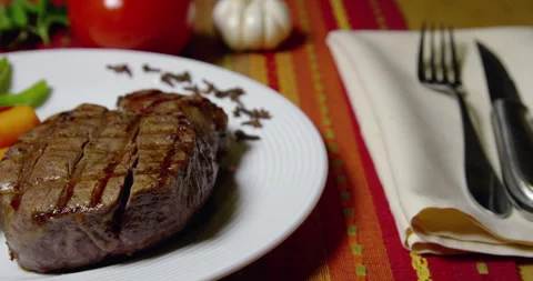 Beef Fillet Mignon Grilled and Vegetables on White Plate Stock Footage 243478644
