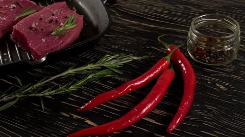Beef fillet on a pan with pepper, rosemary and garlic. Vídeo Stock 74267053