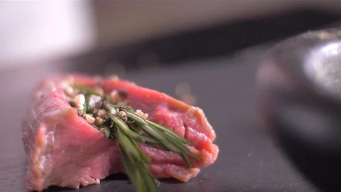 Beef fillet slices wrapped being secure with  twine. slow motion Vídeo Stock 106924261