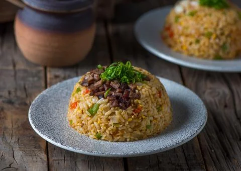 Beef Fried Rice served in a dish isolated on wooden board side view Foto stock