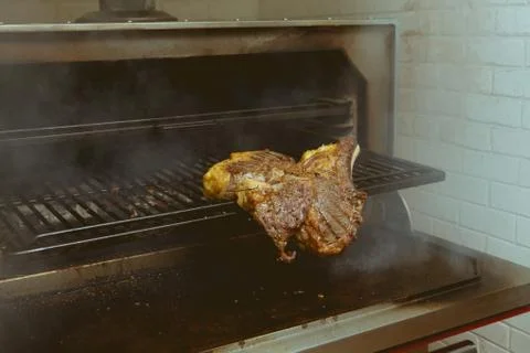 Beef on grill oven in five star hotel restaurant for luxury dinner party, Blu Stock Photos