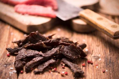 Beef Jerky on wooden background Stock Photos