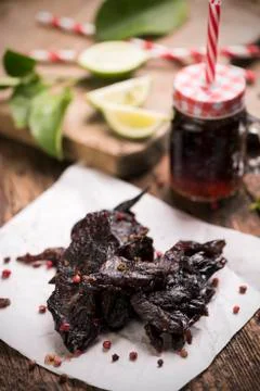 Beef Jerky on wooden background Stock Photos