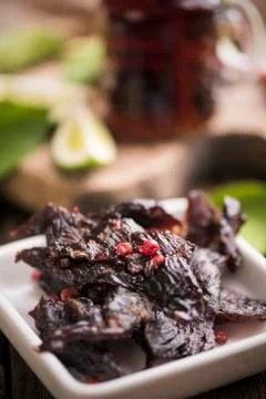 Beef Jerky on wooden background Stock Photos