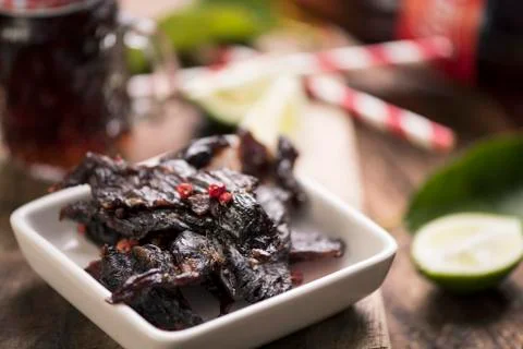 Beef Jerky on wooden background Stock Photos