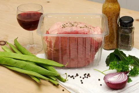 Beef joint ready for roasting, with beans and bay leaves Stock Photos