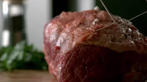 BEEF JOINT TIED UP WITH STRING. Slow motion. Stock Footage 41204276