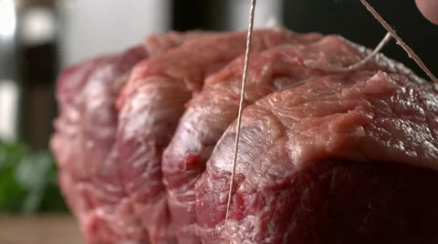 BEEF JOINT TIED UP WITH STRING. Slow motion. Stock Footage 41204599