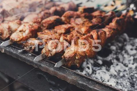 Beef kebab. Fresh roasted meat at grill, bbq, closeup Stock Photos