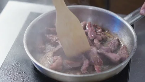 Beef meat are fried onto a pan. Stock Footage 154452216