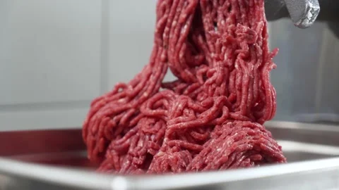 Beef meat in minced meat on a meat grinder at a meat factory, super close up. Video stock 239013426