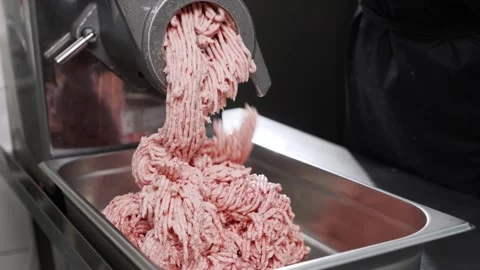 Beef meat in minced meat on a meat grinder at a meat factory. Stock Footage 241471579