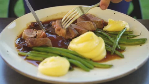 Beef medallions with mashed potatoes and asparagus on a plate Stock Footage 280380673