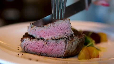 Beef medium Eating Beef Steak with fork and knife POV. Slow motion, close up. Stock Footage 291988864