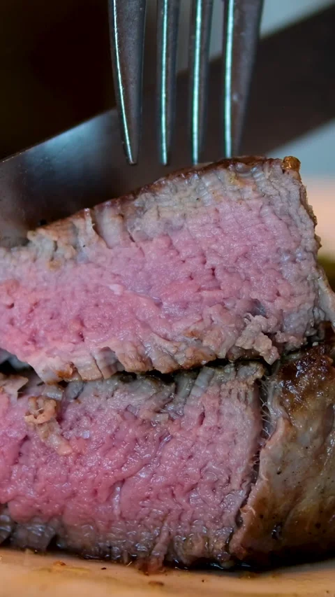 Beef medium Eating Beef Steak with fork and knife POV. Slow motion, close up. Stock Footage 292452514