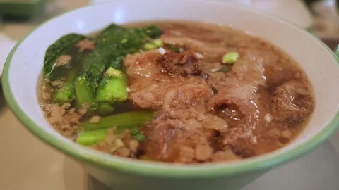 Beef noodles consists of tender beef served with noodles in a flavorful broth. 動画素材 325725764