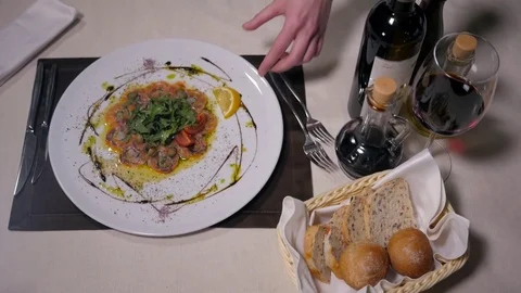 Beef o fish carpaccio with parmesan, lemon and arugula in modern restaurant, top Stock Footage 72567955
