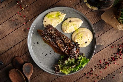 Beef pepper steak with celery puree dish Stock Photos