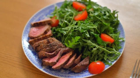 Beef on a plate with arugula Stock Footage 121086263