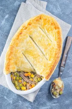 Beef pot pie or deep dish pie in baking dish, crust broken open, vertical, top 스톡 사진