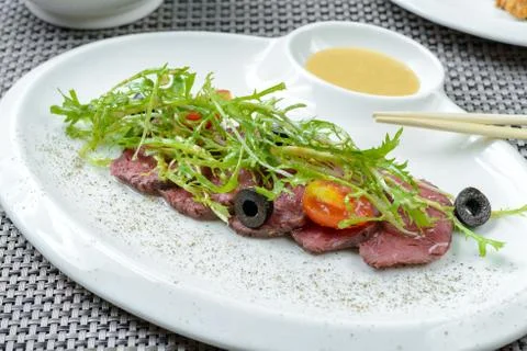 Beef with prepared dandelion Stock Photos